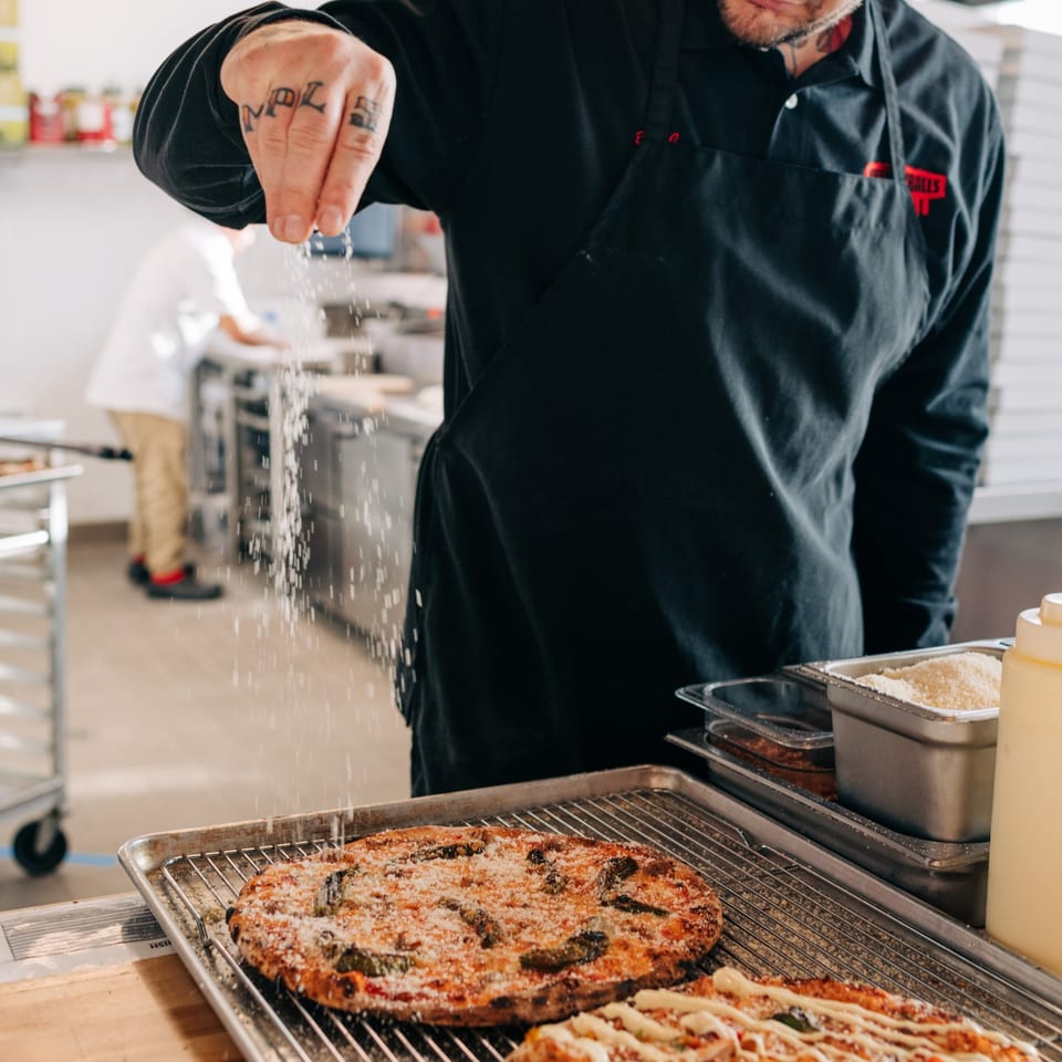 Hand-stretching the dough