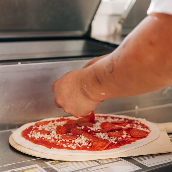 Laying pepperoni over fresh mozzarella